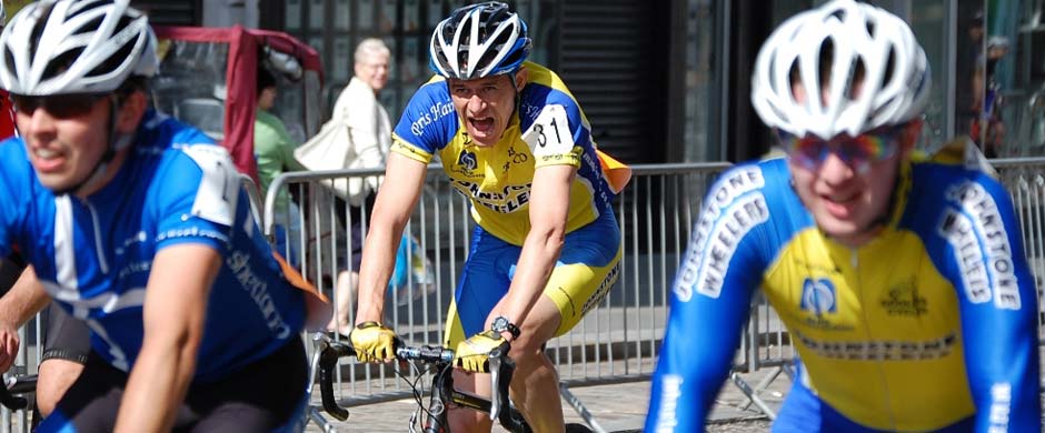 Three Johnstone Wheelers riders sprinting shoulder to shoulder